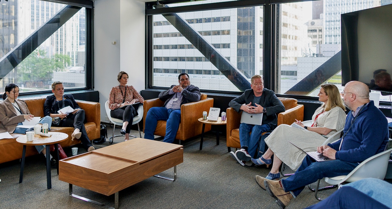 Group discussion on sofas featuring 10 people